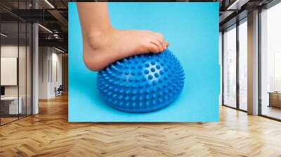 children's feet with a blue balancer on a light blue background, treatment and prevention of flat feet, valgus deformity of the foot Wall mural