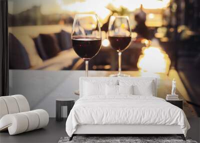 Two glasses of red wine on a rooftop bar terrace with a city view Wall mural