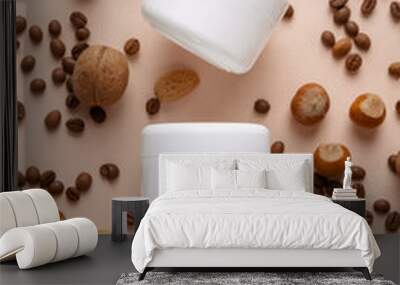 Mockup for cosmetic brand with nuts and coffee. The concept of eco organic products, minimalism style. Cosmetic container on a beige background, next to natural hazelnuts. Face and body skin care. Wall mural