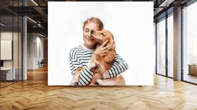 child girl with a pet spaniel dog on a white background Wall mural