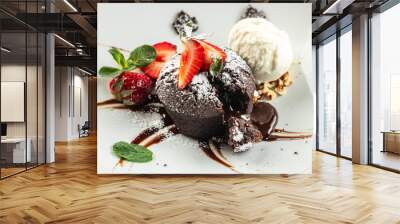 chocolate lava cake with fresh strawberries, ice-cream ball and mint, Food recipe background. Close up Wall mural