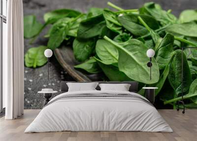 Close up Spinach. Raw organic fresh baby spinach leaves in a metal bowl on dark background. Food recipe background., top view Wall mural