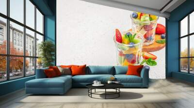 fruit dessert, Fresh summer fruits on a light background, kiwi, banana, strawberry, lime, blueberry and orange. healthy summer concept Wall mural