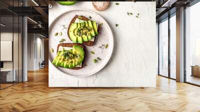 Healthy avocado toasts with rye bread, sliced avocado, cheese, pumpkin, nut and sesame for breakfast or lunch. Vegetarian food. Vegan menu. Food recipe background. Close up Wall mural