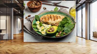 ingredients for a ketogenic diet avocado, grilled chicken fillet, quail egg, spinach, walnut. Healthy fats, clean eating for weight loss, Food recipe background. Close up, top view Wall mural