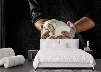 Male hands making dough for pizza. Beautiful and strong men's hands knead the dough make bread, pasta or pizza Wall mural