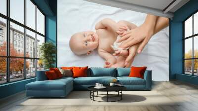 Mother cleaning up and wipes body and leg baby by wet tissue. Cleaning wipe, pure, clean. happy emotions of newborn baby Wall mural