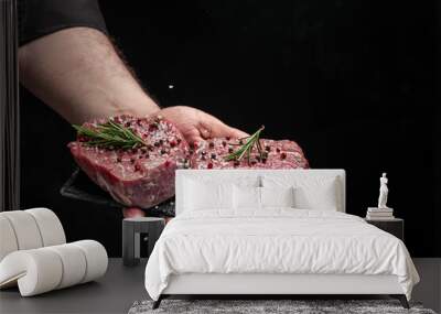 Preparing fresh beef or pork on a dark background. Chef salts steak in a freeze motion with rosemary and spices. Long banner format. Wall mural