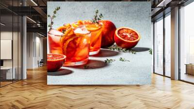 refreshing alcoholic cocktail with Sicilian red oranges, Aperitif on a light background. Long banner format. top view Wall mural