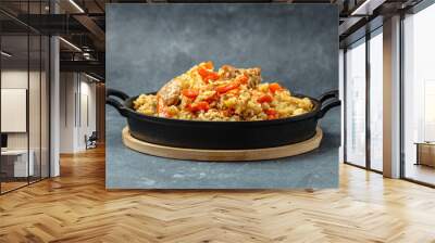 Uzbek food pilaf in cast-iron pan. banner, menu, recipe place for text Wall mural