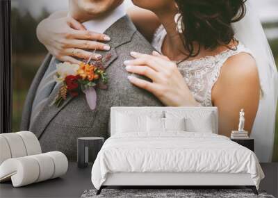 Stylish couple on their autumn wedding day and their accessories: boutonniere, bracelet Wall mural