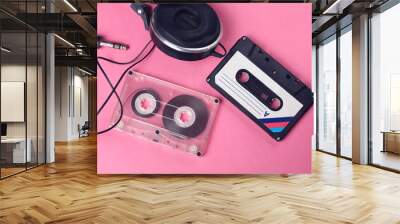 group of two audio retro vintage cassette tape and headphones 80s style on pink background Wall mural