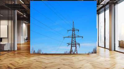 Power electrical transmission old tower with wires and ceramic white insulators on the background of bright blue sky bottom view Wall mural