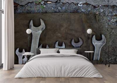 Wrench old retro tool kit on the dark brown  fabric texture Wall mural