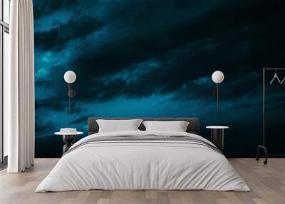 Black green blue night sky with clouds. Dark dramatic skies background for design. Cloudy, rainy, windy, stormy weather. Or a frightening, spooky, creepy, nightmare concept. Wall mural