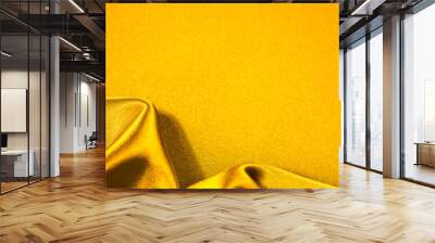 Yellow orange fabric background. Silk satin with soft wavy folds. Drapery shiny fabric background with copy space for your design. Bright web banner. Luxurious golden background. Wall mural