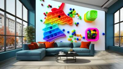 Simple Dimple Pop-it in rainbow color, filled with multicolored pampons. Colored pampons are in a pink cup.  Wall mural