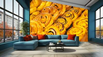 Delicious dessert in the cafe window .Croissants, buns and other appetising pastries. Wall mural