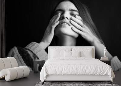 emotions of sadness and frustration on the face of a young girl, black and white authentic portrait of facial expressions on a dark background in the studio Wall mural