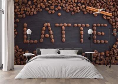  The inscription of coffee beans. Latte word made from coffee on a black background. Wall mural