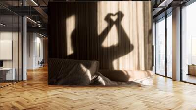 Woman making heart shadow with her hands on the wall. World mental health day, hope and love. Valentines 14 February Wall mural