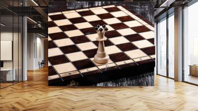 
wooden chess pieces with a playing board against a dark background Wall mural