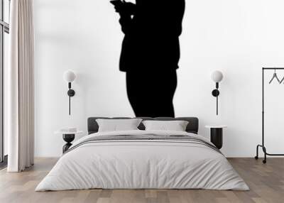 Young woman holds smartphone in her hand. Isolated silhouettes of people on a white background Wall mural