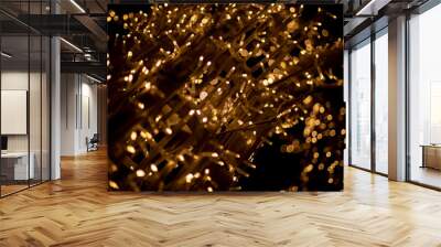 Yellow lights in dark. New Year's texture. Wood made of garlands. Lots of lights. Wall mural