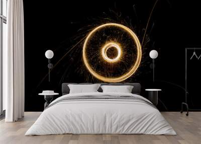 Sparks from the circular rotation of lights on a black background Wall mural