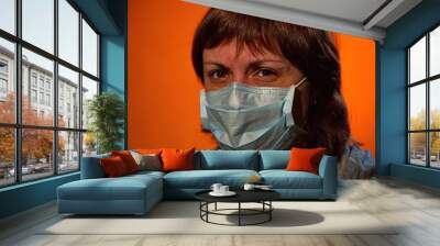 Portrait of a young woman in a medical mask. Wall mural