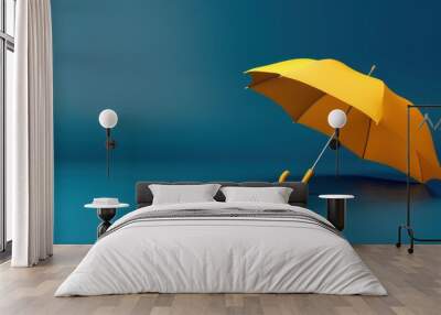 A yellow umbrella, open and tilted, resting on a blue surface with water droplets Wall mural