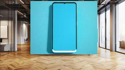 Smartphone with blank screen on blue background Wall mural