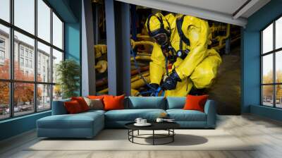 Rescuers in a radiation protection suit. Wall mural