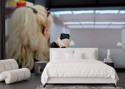 Woman shooting in virtual shooting gallery Wall mural