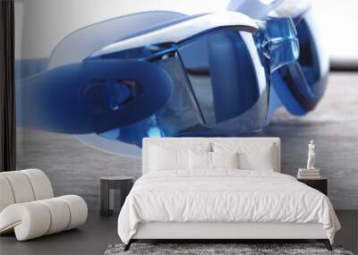 Professional Blue glasses for swimming on a gray background Wall mural