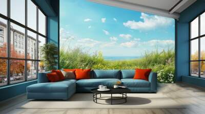 Serenity in a lush meadow by the ocean under a bright blue sky on a sunny day Wall mural