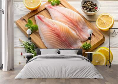 two fillets of raw fish, spices, lemon and herbs on a chopping board on a gray wooden background close-up Wall mural