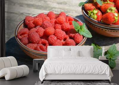 Two clay cups with berries strawberries,raspberries and sprigs of green mint  Wall mural