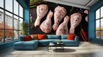 raw chicken drumsticks with spices and herbs on black board Wall mural