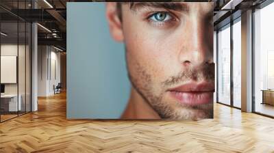 Beautiful and sexy looking man close-up studio portrait. Model with smokey eye shadows and bright skin Wall mural