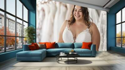 Plus size woman trying on wedding dress. Happy bride excited smile for wedding, happiness and marriage Wall mural