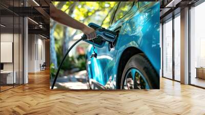 summer EV Charging: Close up Person Powering Electric Vehicle on Sunny Day Wall mural