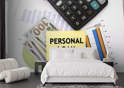 On a financial document with dollars near the calculator is a yellow sheet on which the inscription personal loan. Business and financial concept Wall mural