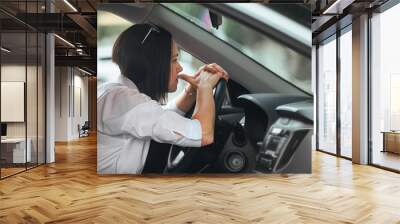 young beautiful woman driver driving her car is upset and worried, has anxiety and negative feelings Wall mural