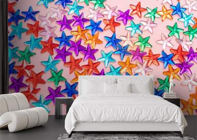 Multi-colored rhinestones in the form of stars on a pastel pink background. The concept of a holiday, party, birthday. Minimalism. Copy space. Wall mural