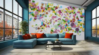 Confectionery multicolored sprinkles on a white background. Wall mural