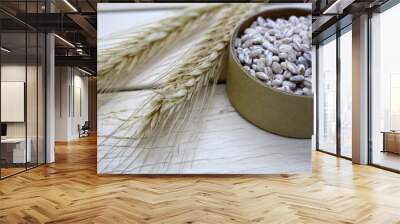 Dry ears of wheat on a wooden background. Wall mural