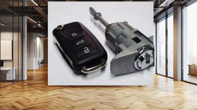 New folding ignition key with three buttons of the anti-theft control system for a modern car and a new cylinder lock on a white background. Ensuring the safety and security of the car. Quality parts. Wall mural