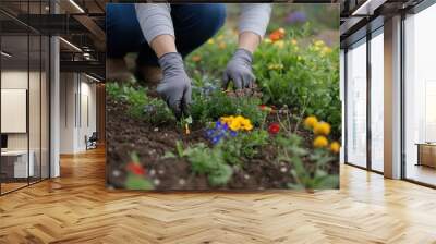 A person planting wildflowers in an urban garden to attract pollinators and support biodiversity Wall mural