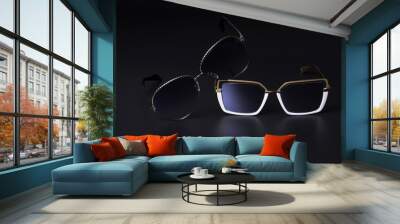 Close-up of two sunglasses on a black background. Vision protection concept. Wall mural